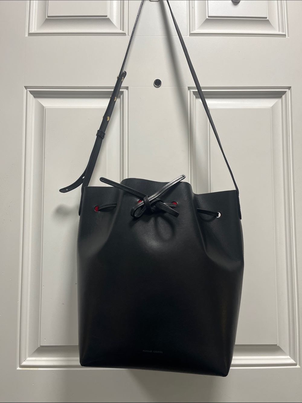 Mansur Gavriel Black Leather Bucket Shoulder Bag with Red Eyelet Accents